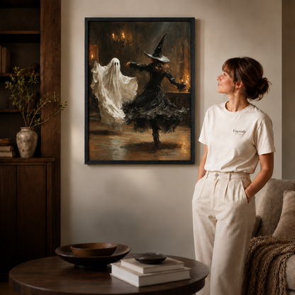Black-framed witch and ghost dance artwork styled in a cozy neutral living room.