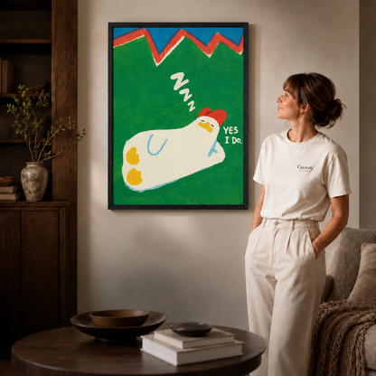 Sleeping chicken artwork with hand-painted lettering in a slim black frame beside a woman.