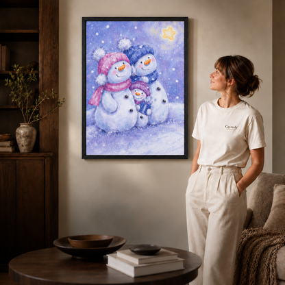 Pastel snowman family artwork in a slim black frame beside a woman in white.
