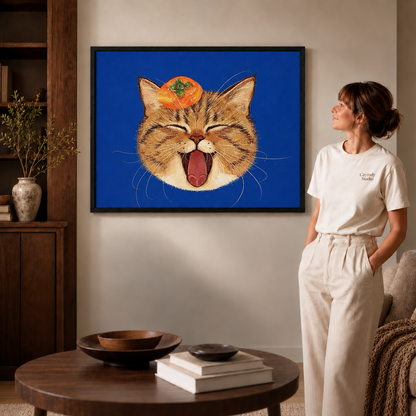 Smiling tabby cat canvas art above a wooden cabinet, with a seated man looking toward it.