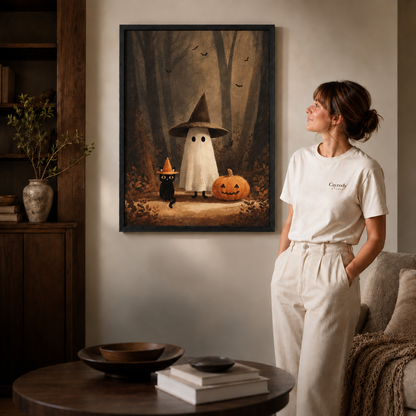 Black-framed ghost and black cat artwork styled in a cozy neutral living room.