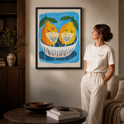 Black-framed golden pear and cocktail artwork styled in a cozy neutral living room.