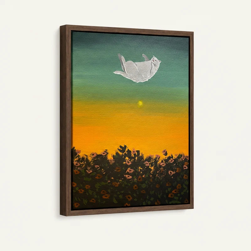 Framed canvas close-up of white cat drifting belly-up through golden teal gradient sky above wildflowers