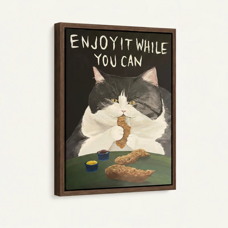 Framed canvas side view of chubby tuxedo cat eating fried chicken with dipping sauces on dark background