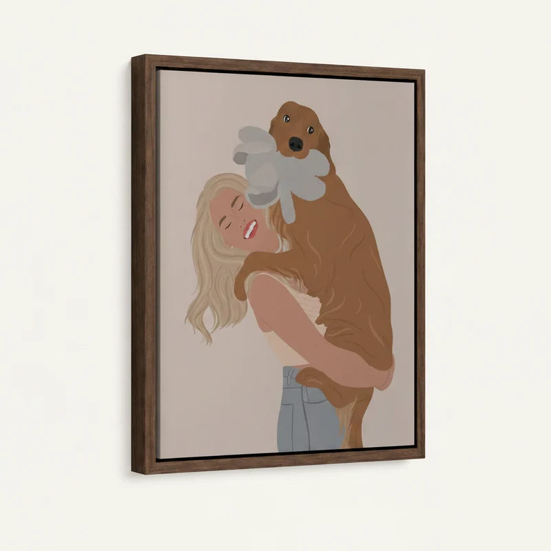 Framed canvas side view of laughing woman lifting brown dog with plush toy on warm blush background