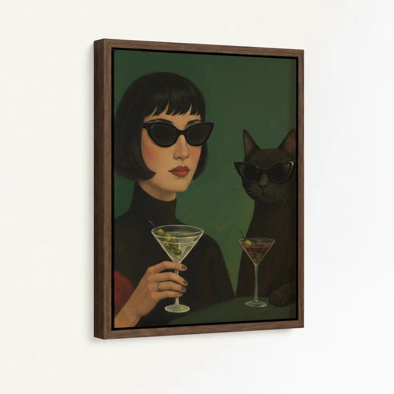 Framed canvas close-up of retro woman in cat-eye sunglasses and black cat holding martini glasses