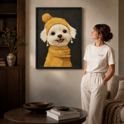 White dog portrait in a black frame beside a woman dressed in white.