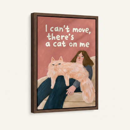 Framed funny cat canvas print showing woman stuck under fluffy cat on sofa