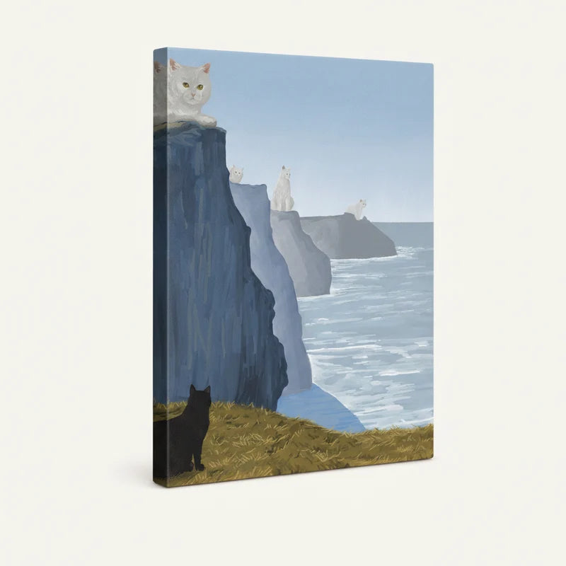 Gallery-wrapped canvas close-up of cats on dramatic coastal cliffs with pale blue ocean stretching to the horizon
