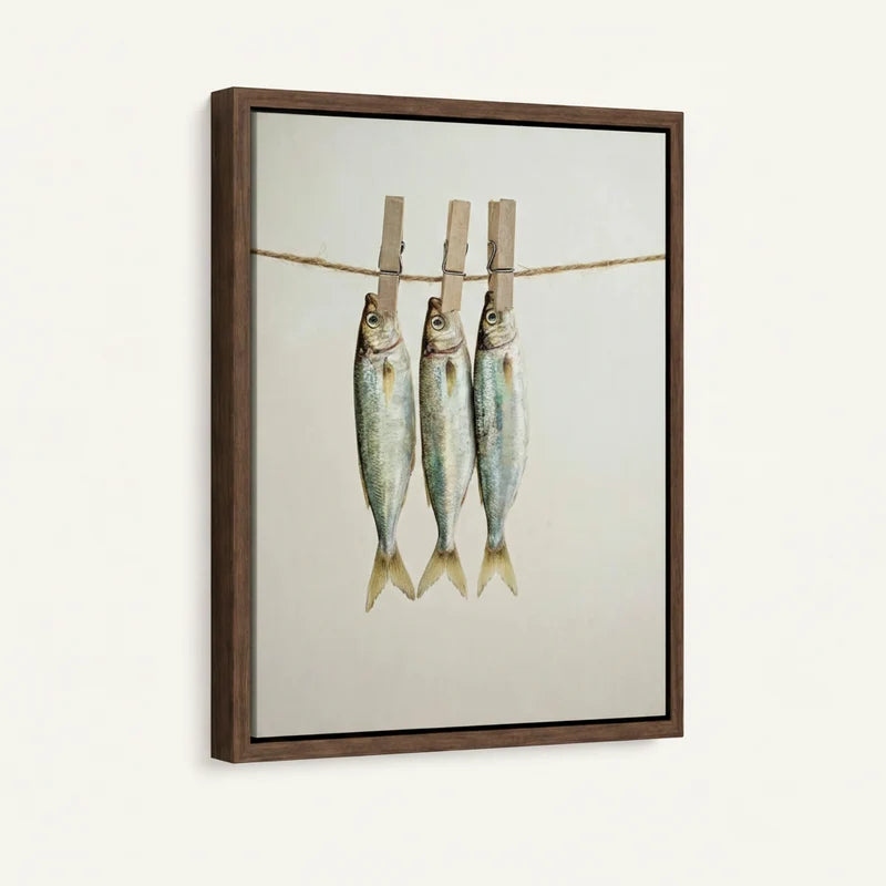 Framed minimalist fish canvas print with walnut frame shown at angle against white wall