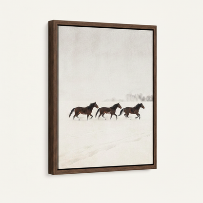 Framed canvas wall art featuring three horses running through winter snow on clean white background
