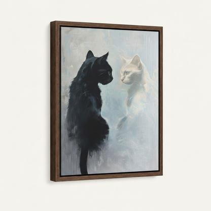 Framed canvas close-up showing black cat facing white cat on misty blue-grey with walnut frame