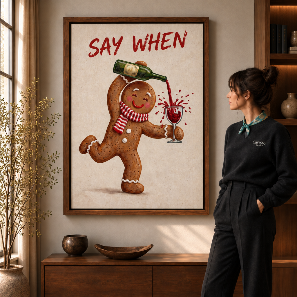 Framed Say When gingerbread wine canvas above a wooden console, viewed by a woman in a black sweater.