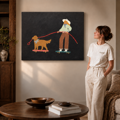 Gallery-wrapped whimsical canvas of a cowgirl and her golden dog skateboarding, hanging frameless on a beige wall.