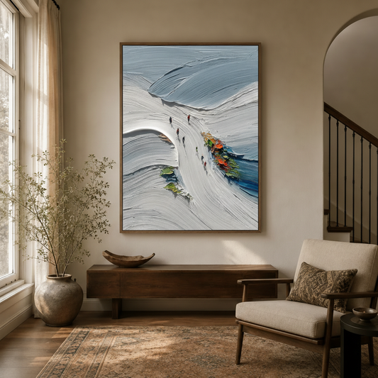 Framed ski mountain snow landscape canvas displayed above console table in warm neutral entryway with arch detail