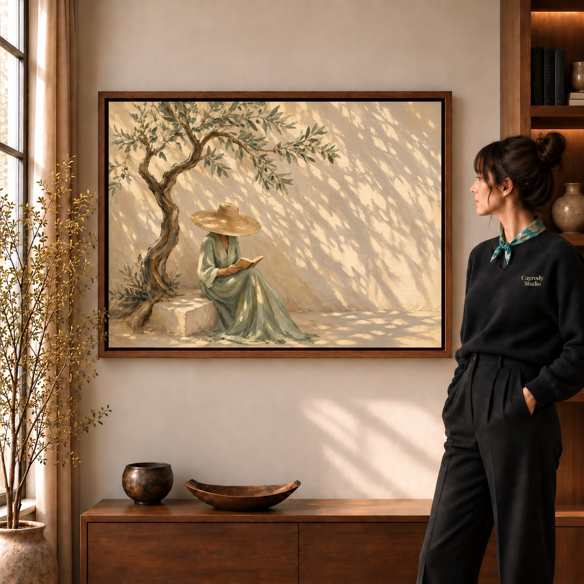 Olive tree reader canvas wall art walnut framed option displayed beside a standing woman in the warm room.