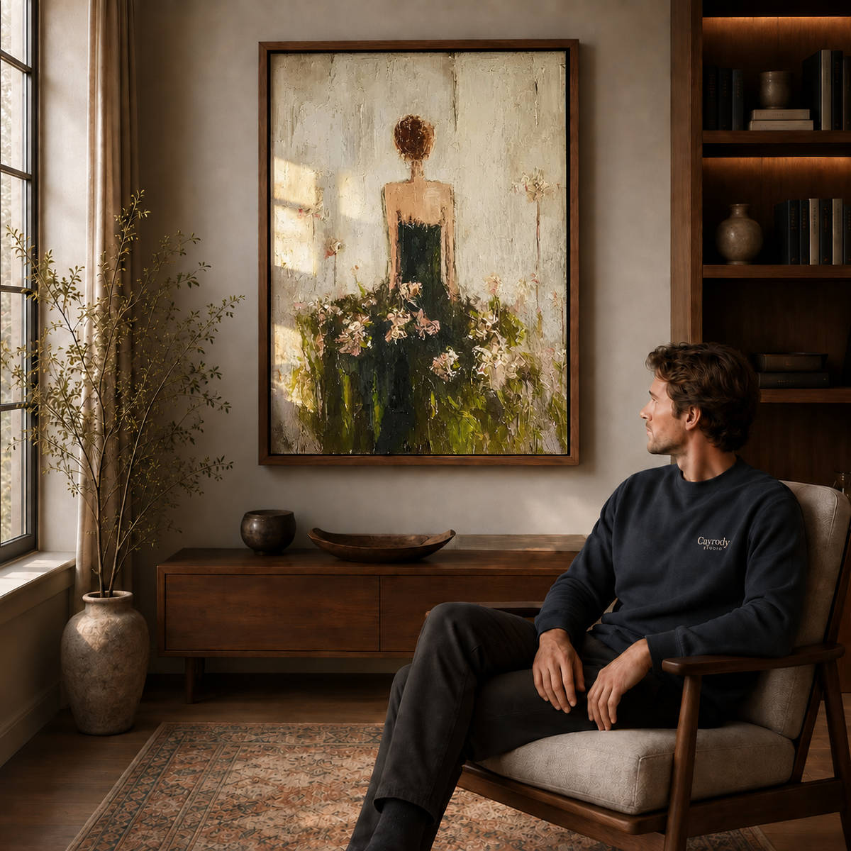 Floral woman canvas wall art in a walnut frame above a seated man near a sunlit window.