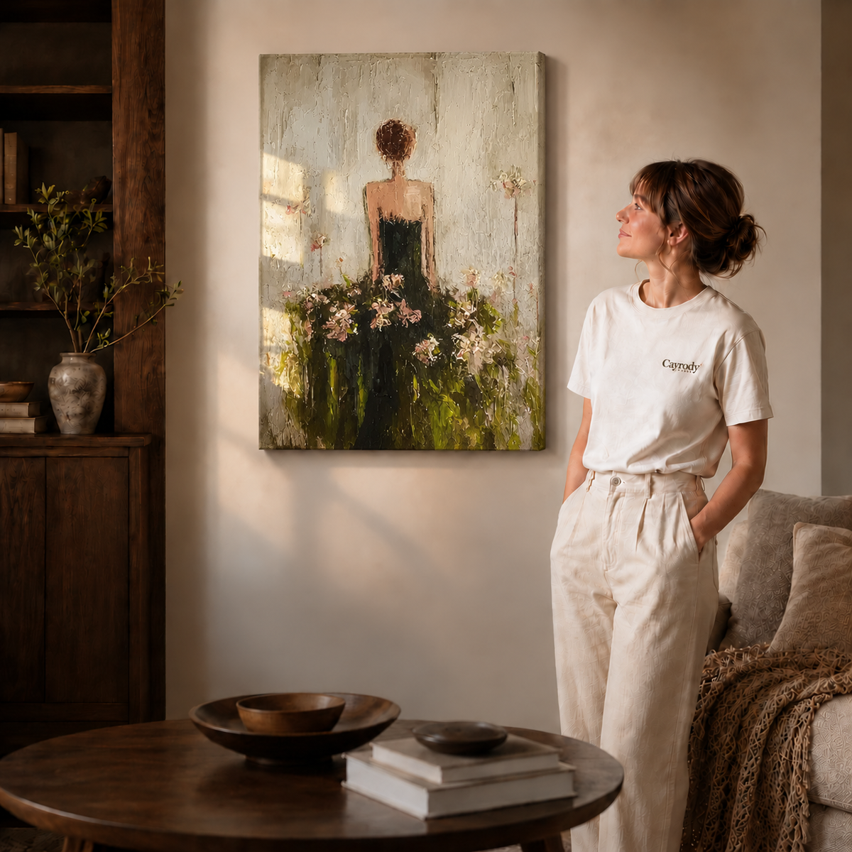 Floral woman canvas wall art shown on unframed gallery wrapped canvas beside a woman in white clothing.