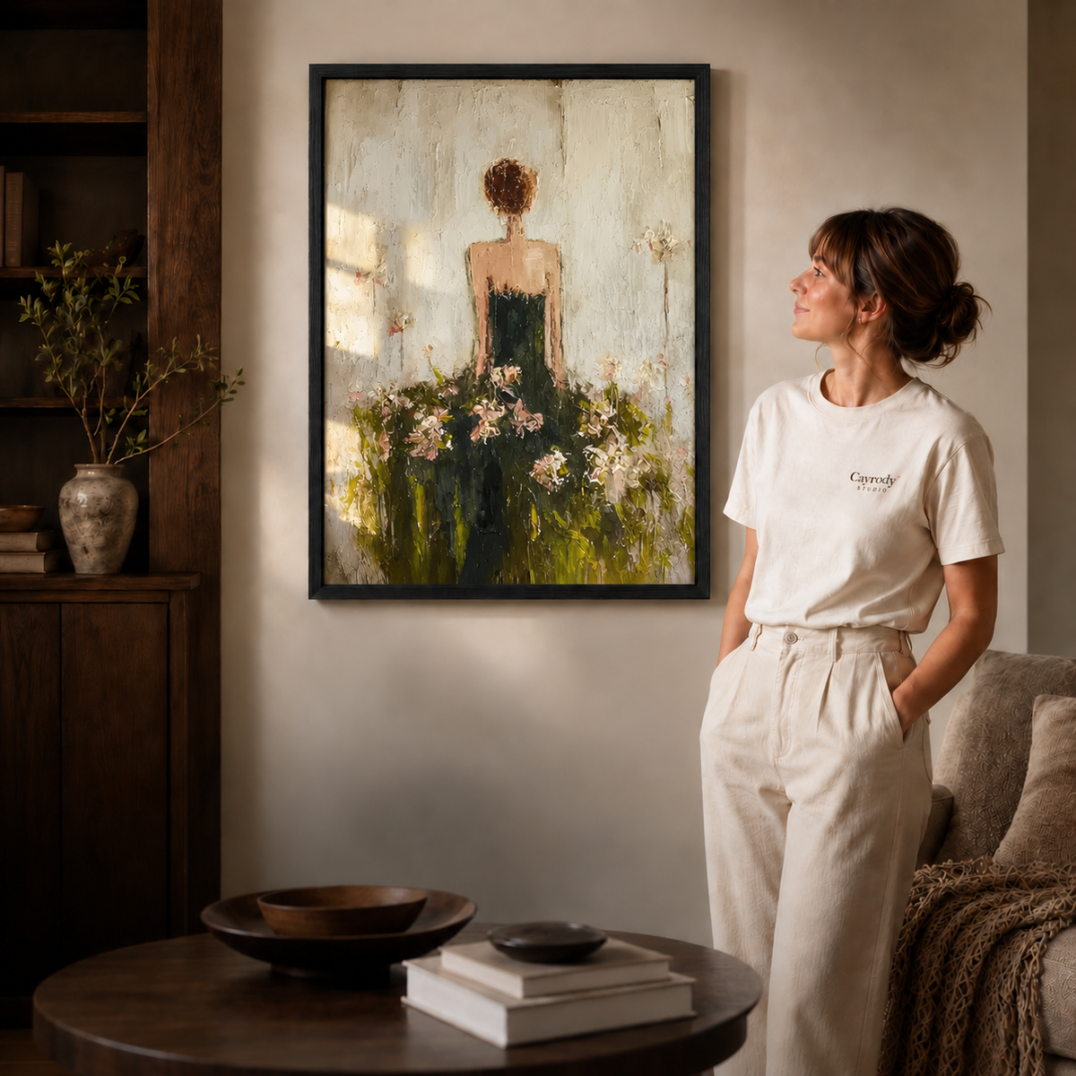 Floral woman canvas wall art black framed option shown beside a woman in the softly lit living room.