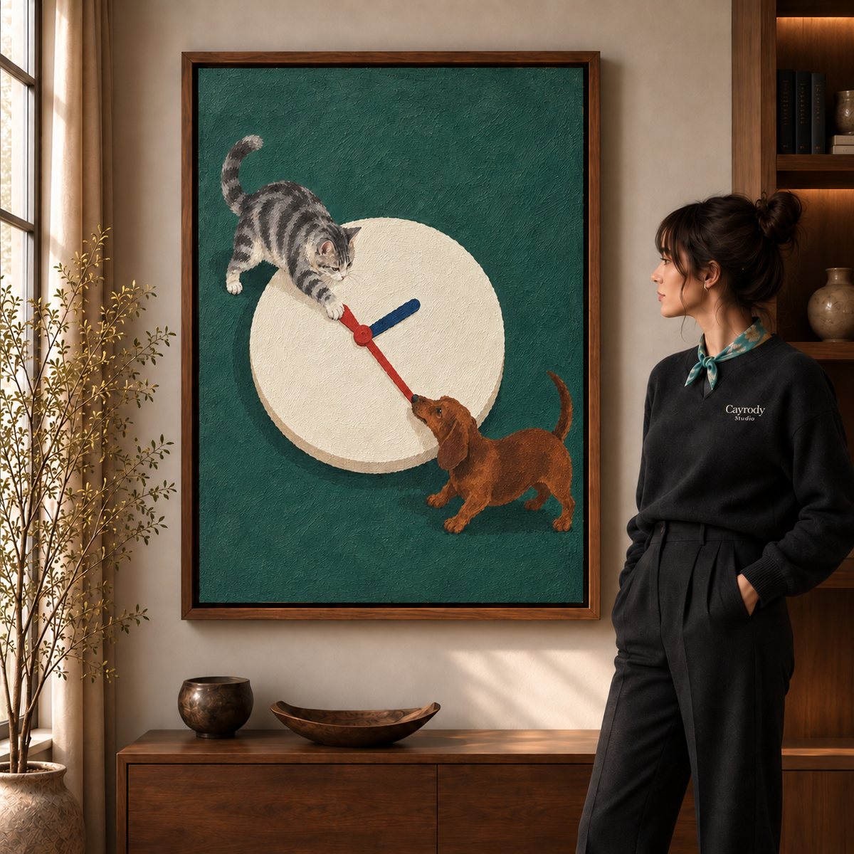 Whimsical cat and dachshund canvas wall art in a walnut frame beside a woman and sunlit window.