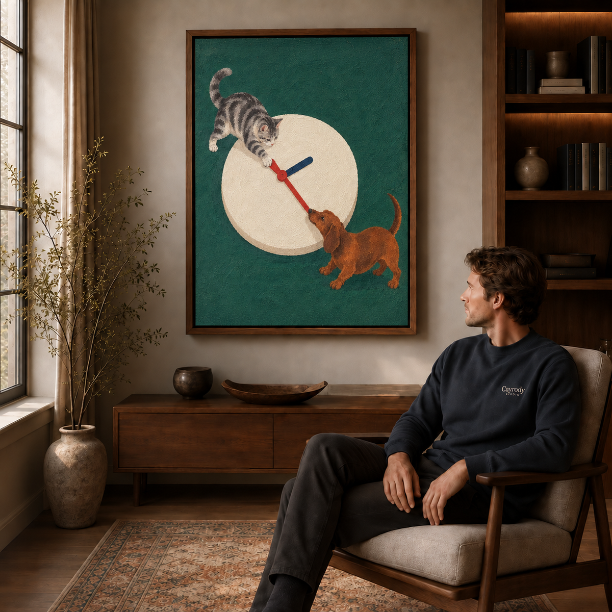 Cat and dachshund canvas wall art displayed above a wooden cabinet beside a seated man.