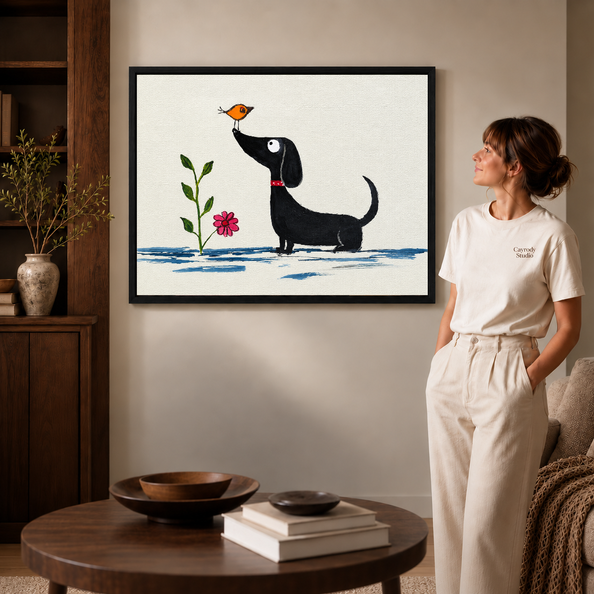 Whimsical dachshund canvas wall art showcasing the black framed canvas option beside a woman wearing white.