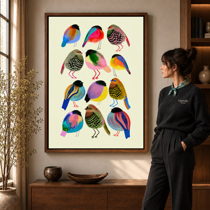 Colorful birds canvas art in a walnut frame beside a woman in a warmly lit living room.