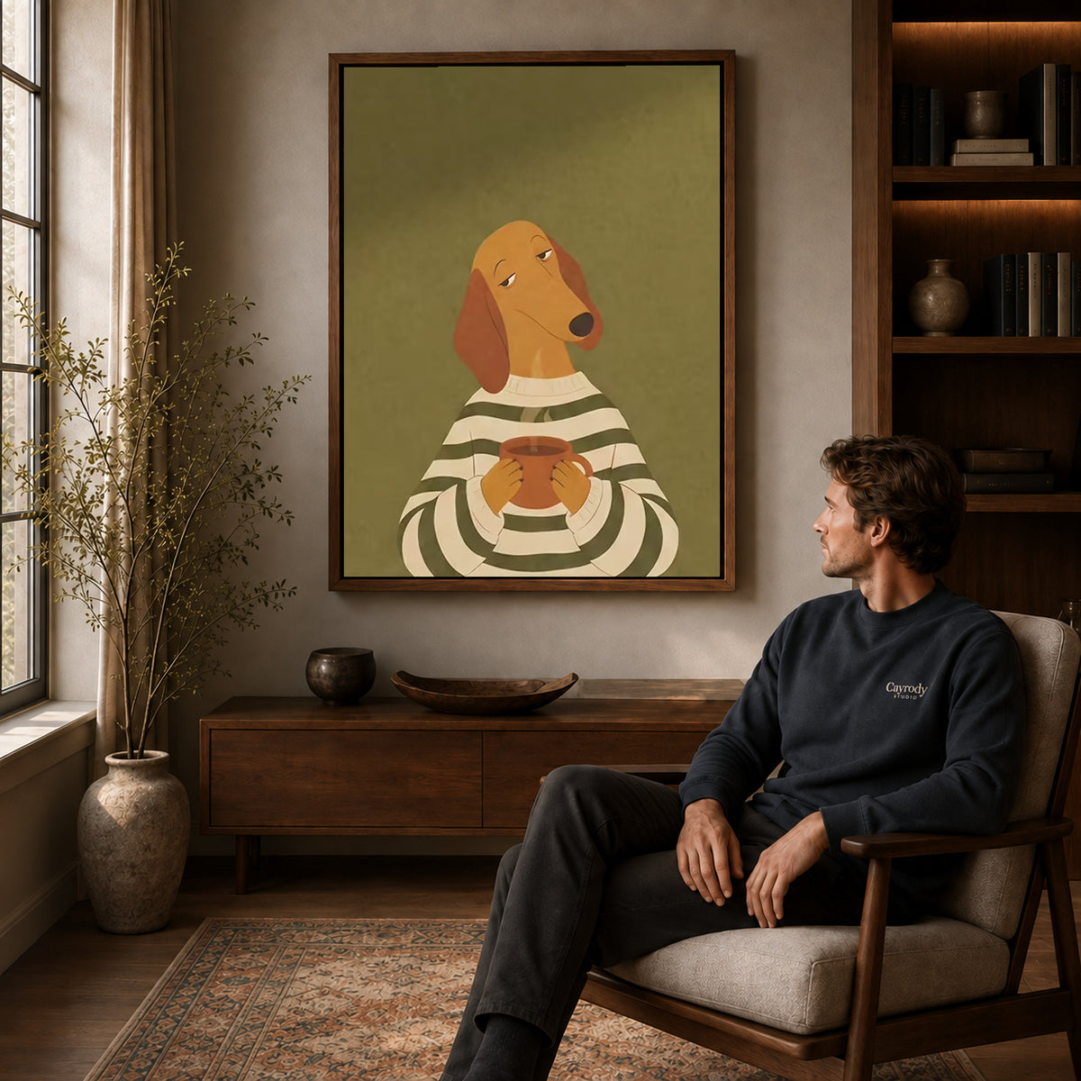 Coffee dog canvas art above a wooden console near a seated man and leafy branches.