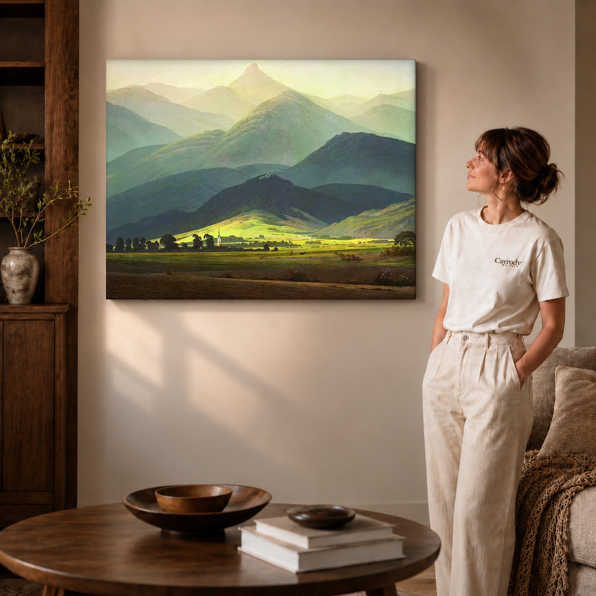 Mountain valley canvas art on gallery wrapped canvas with a visible shaded side edge beside a woman.