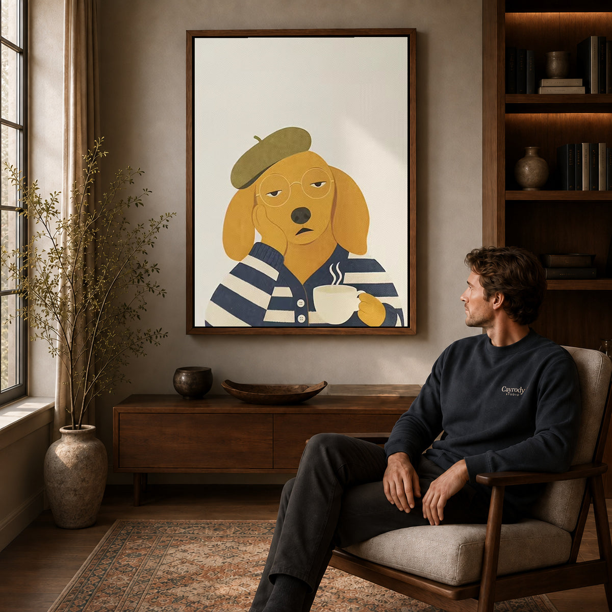 Beret dog canvas art above a wooden console near a seated man and leafy branches.