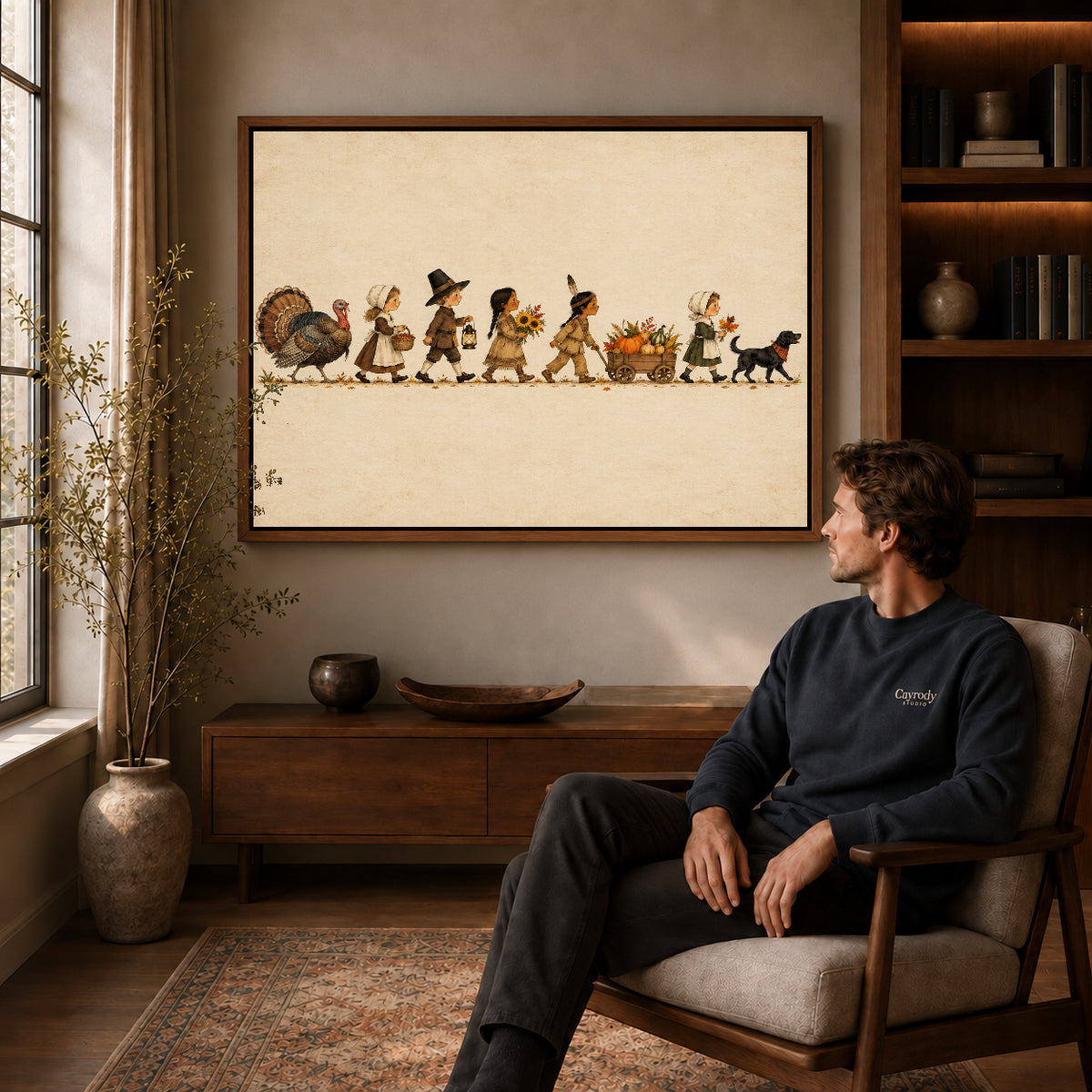 Harvest parade canvas art above a wooden console near a seated man and leafy branches.