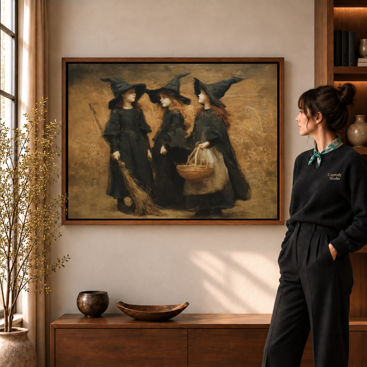 Three witches canvas art displayed in a walnut frame against a warm wall near a wooden console.