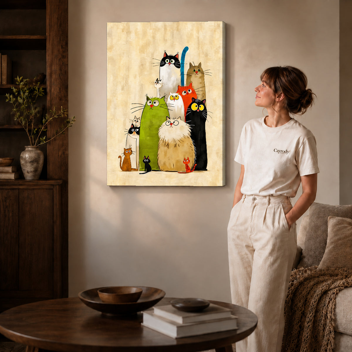 Gallery wrapped colorful cats canvas art with visible canvas edges beside a standing woman.