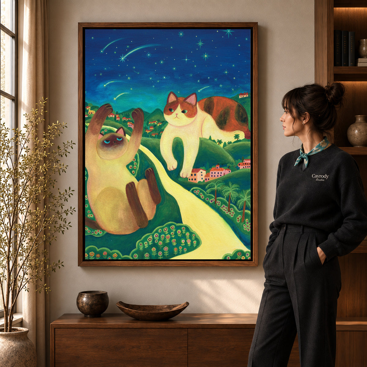 Starry cats canvas art displayed in a walnut frame against a warm wall near a wooden console.