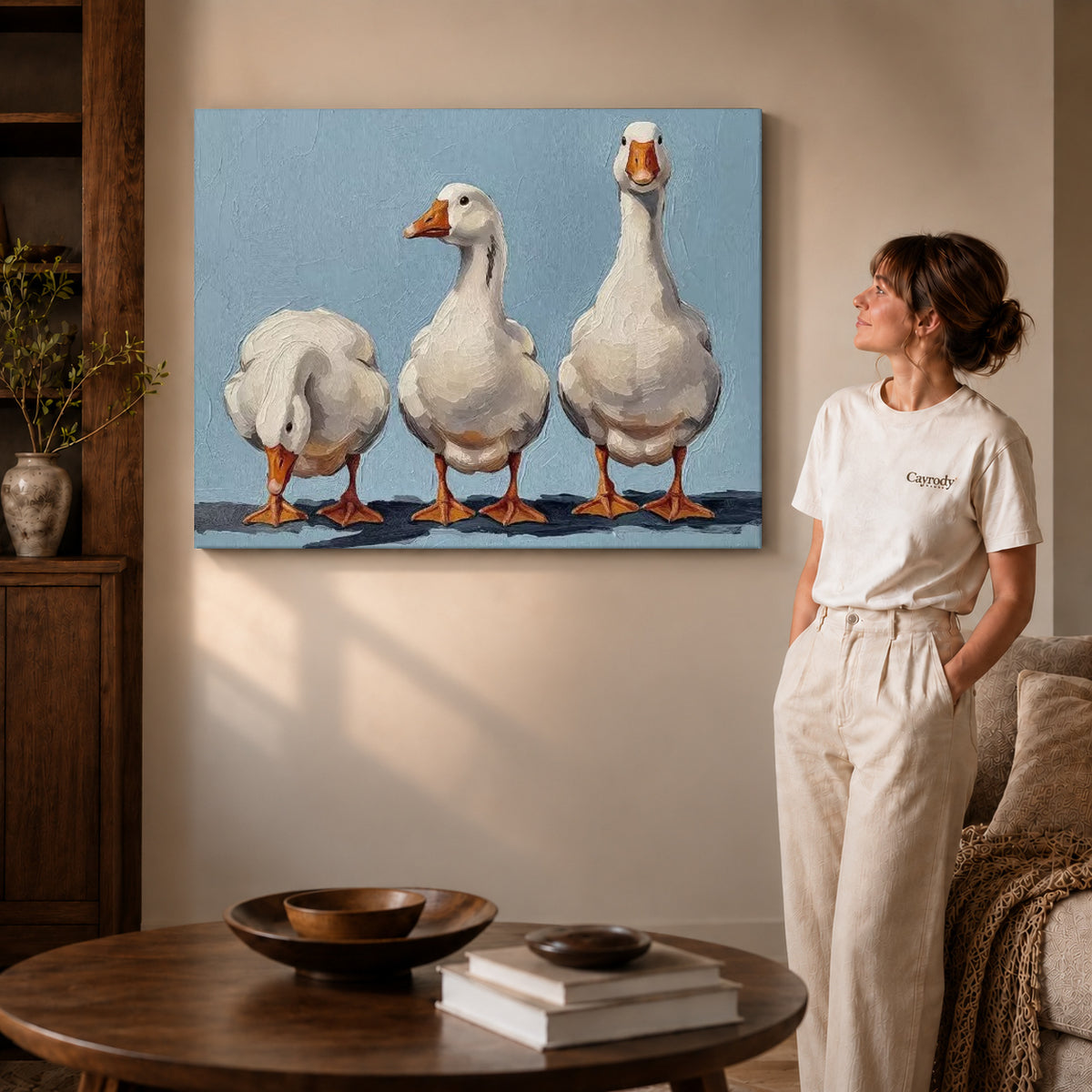 Three geese canvas art on gallery wrapped canvas with a visible shaded side edge beside a woman.
