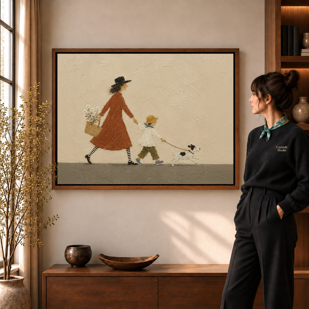 Family walk canvas art in a walnut frame beside a woman in a warmly lit living room.