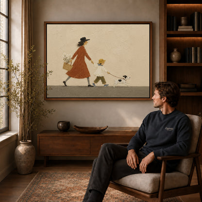 Family walk canvas art above a wooden console near a seated man and leafy branches.