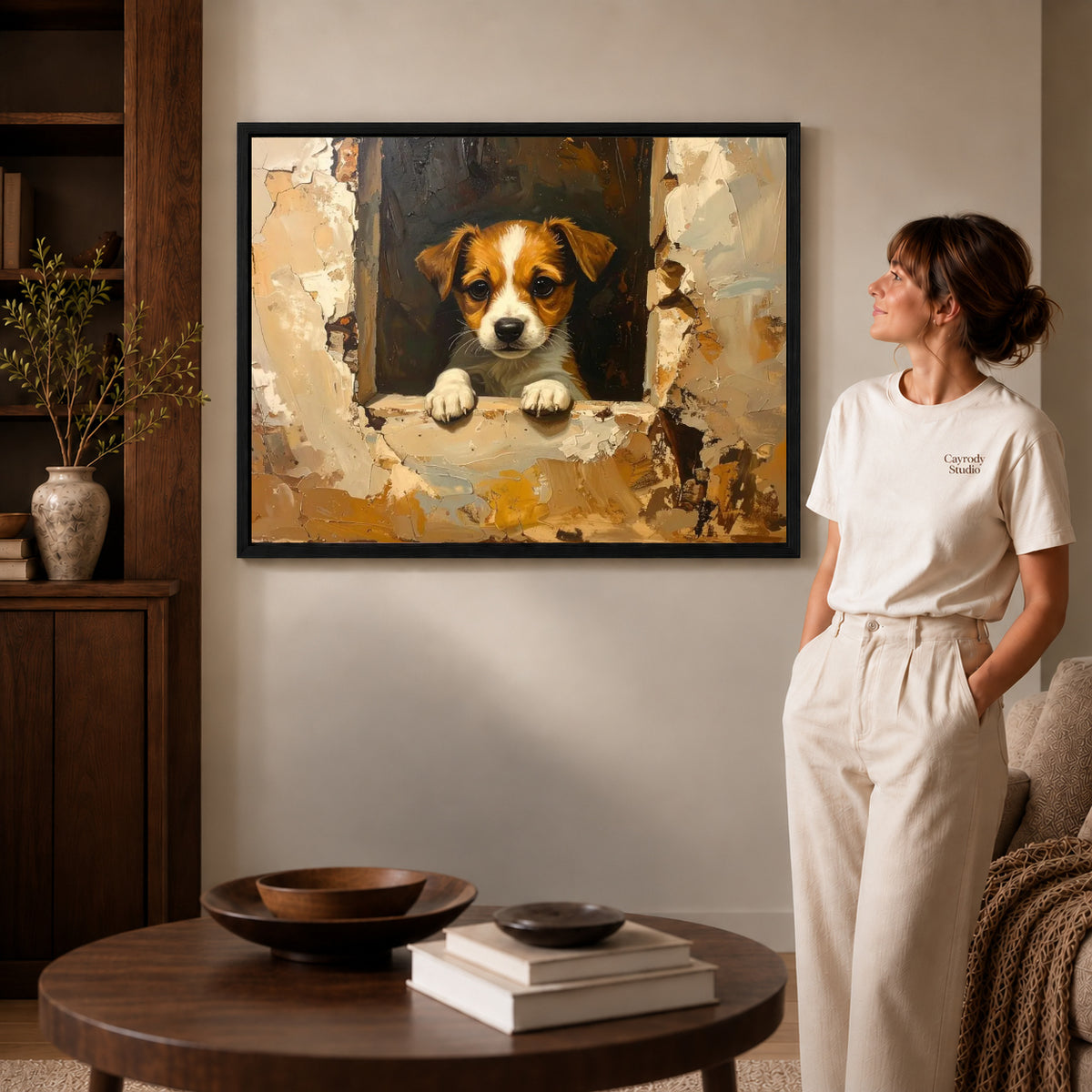 Window puppy canvas art displayed in a black frame beside a woman, with soft room lighting.