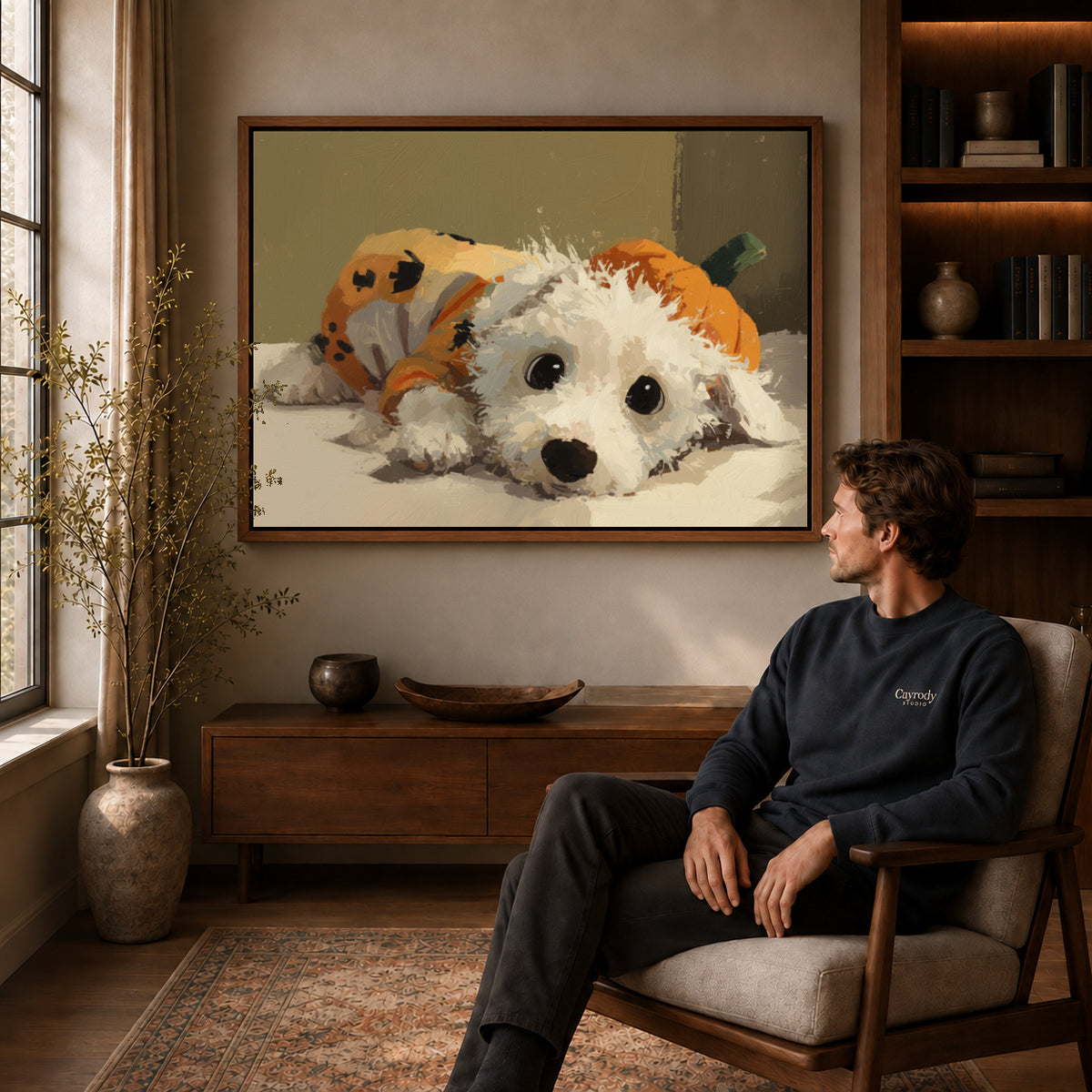 Pumpkin puppy canvas art above a wooden console near a seated man and leafy branches.