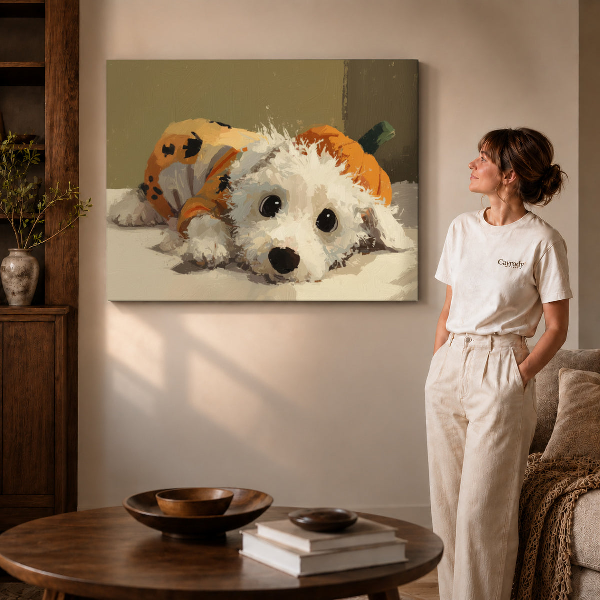 Pumpkin puppy canvas art on gallery wrapped canvas with a visible shaded side edge beside a woman.