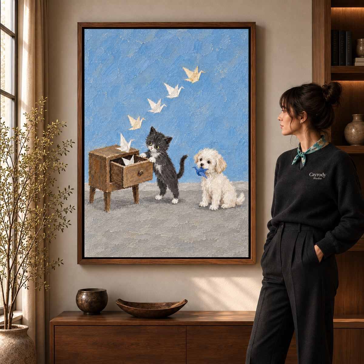 Walnut framed paper crane pets canvas art shown beside a standing woman and a wooden console.