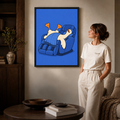 Relaxing duck canvas wall art in a black frame, with orange feet and a blue checked blanket.