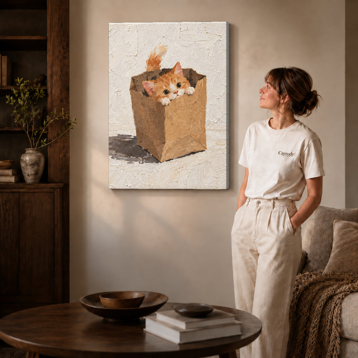 Paper bag kitten canvas art on gallery wrapped canvas with a visible shaded side edge beside a woman.