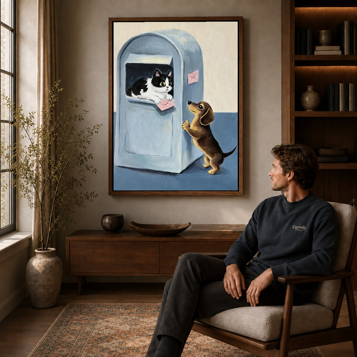 Mailbox companions canvas art above a wooden console near a seated man and leafy branches.