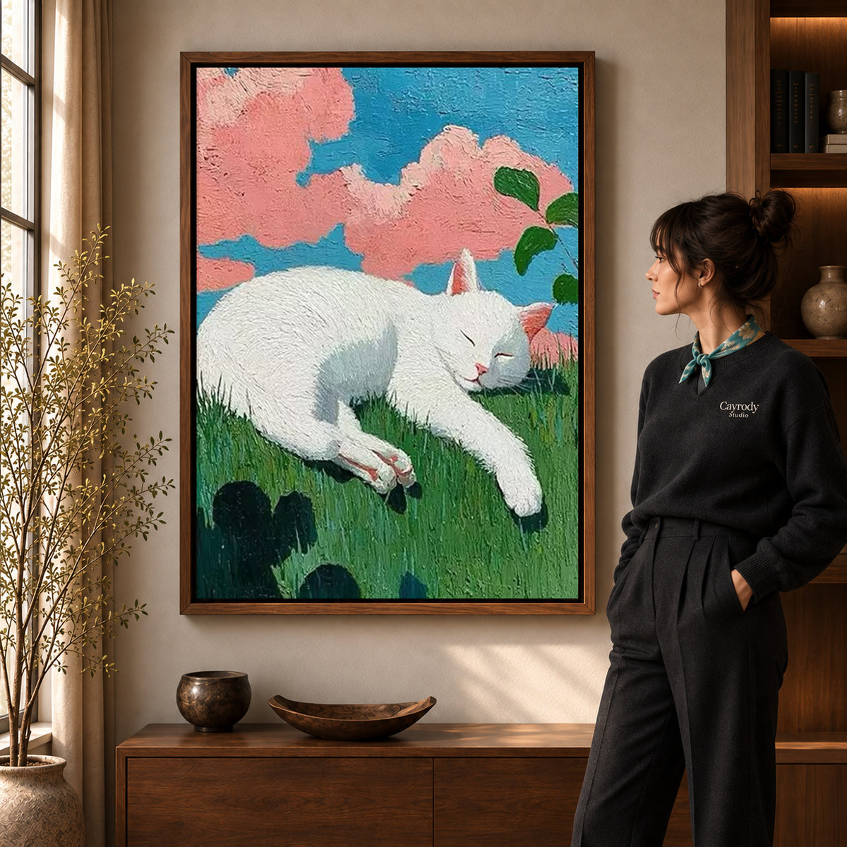 Sleeping cat canvas art displayed in a walnut frame against a warm wall near a wooden console.