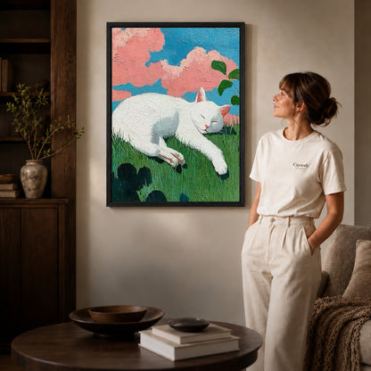 Sleeping cat canvas art displayed in a black frame beside a woman, with soft room lighting.