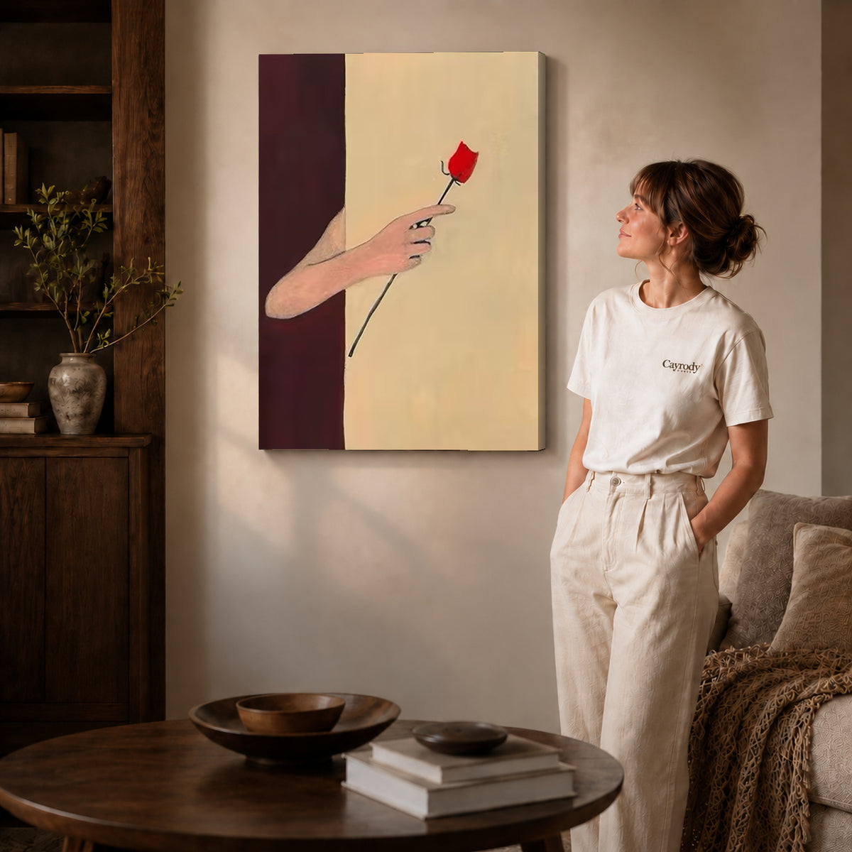 Red rose canvas art on gallery wrapped canvas with a visible shaded side edge beside a woman.