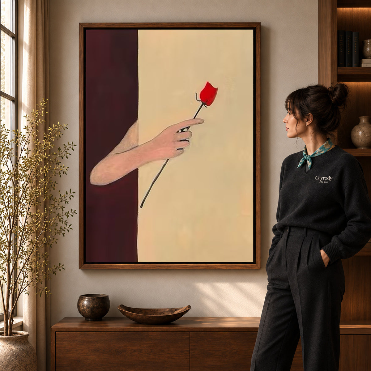 Red rose canvas art displayed in a walnut frame against a warm wall near a wooden console.