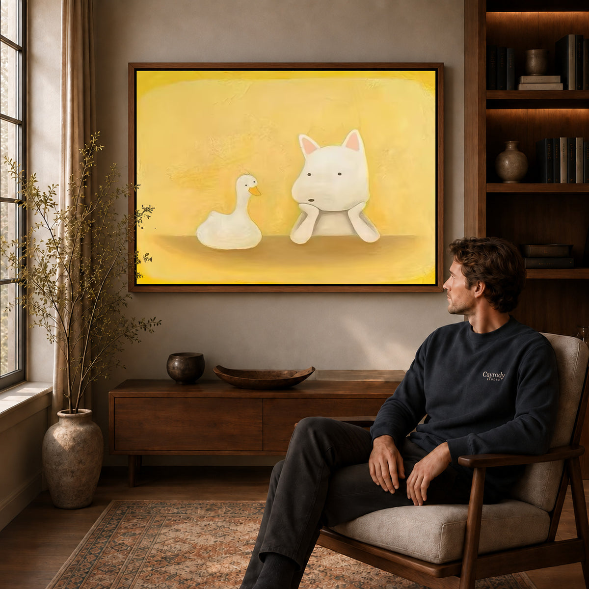 Dog and duck canvas art above a wooden console near a seated man and leafy branches.