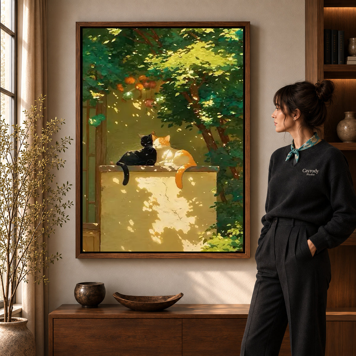 Garden cats canvas art displayed in a walnut frame against a warm wall near a wooden console.
